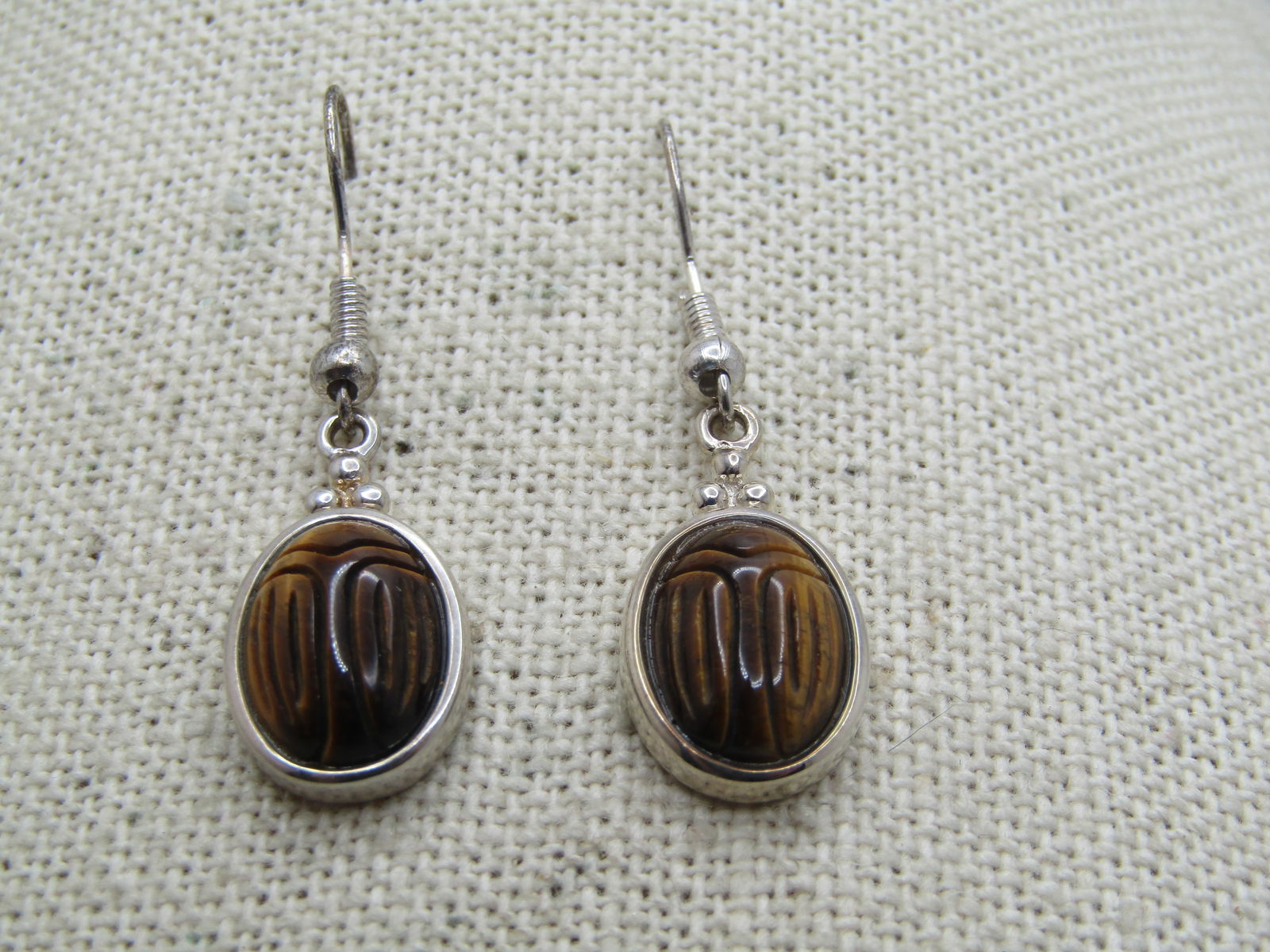 Vintage Tiger's Eye Scarab Earrings, Sterling & Silver tone, 1980's-1990's: Vintage Tiger's Eye Scarab Earrings, Sterling & Silver tone, 1980's-1990's. The scarabs are appx. 5/8" by just under 1/2" wide tiger's eye scrabsm, framed with open back They have three round beads be