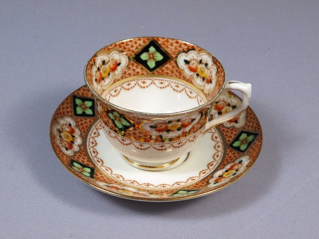 Royal Albert Crown China Devon Lovain Imari Green Coffee Tea Cup Saucer Setting: This is a gorgeous set of Coffee/Tea Cup and Saucer. The set is made by Royal Albert in England. The pattern is close to Devon or Lovain but not the same. It is properly marked with Royal Albert Crown