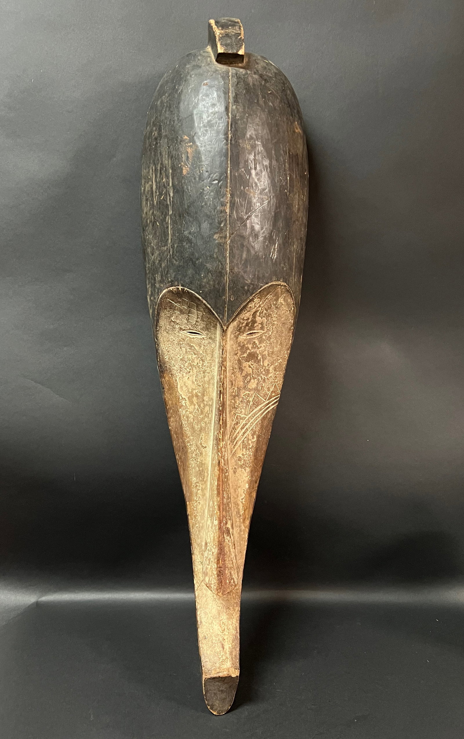 Elongated Fang Mask: Title: Elongated Fang Mask Date/Period: Late 20th Century Dimension: 32" h x 9" w Material: Wood Additional Information: African Tribal Art Elongated Fang Mask Reserve: $120.00 Shipping: Domestic: Fla