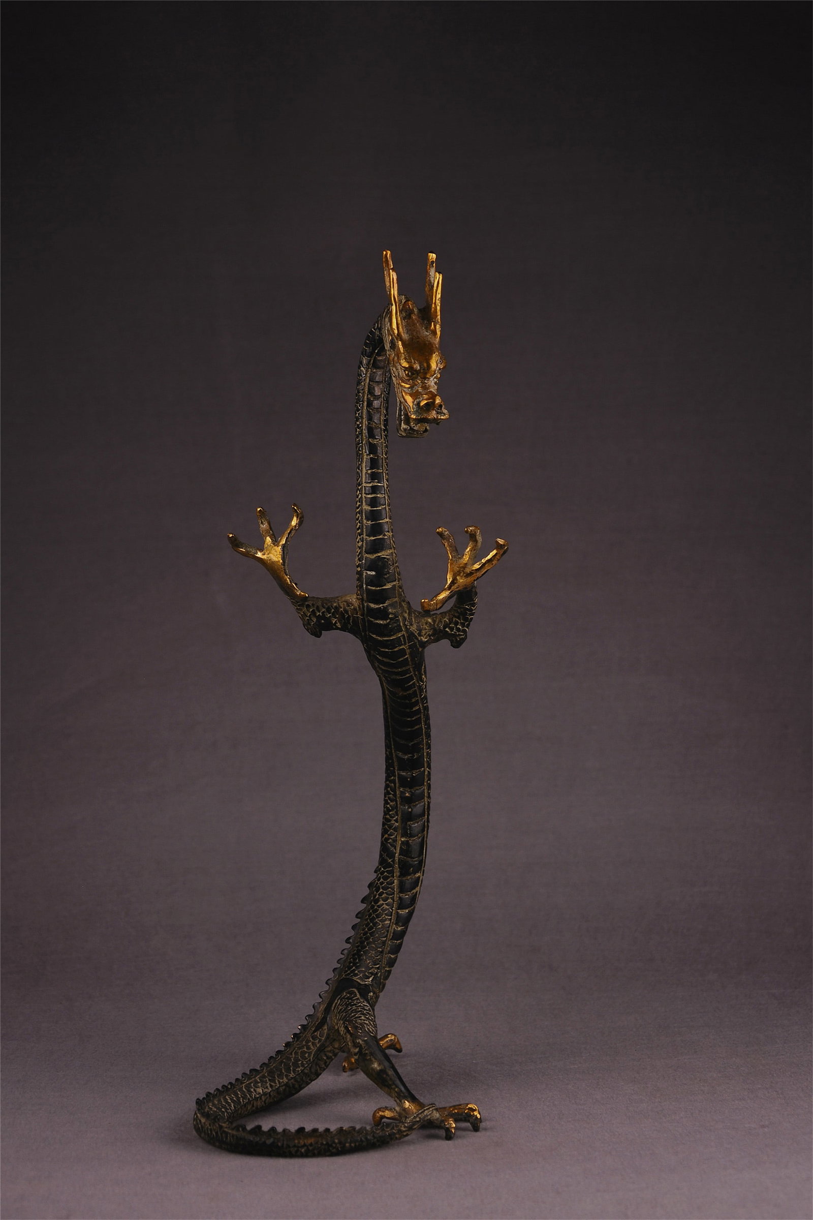 Chinese standing bronze dragon sculpture: Title:Chinese standing bronze dragon sculpture Origin:Asian private collection Date/Period:20th Materials:bronze Description:Size: 210x140x 410mm, a ferocious bronze dragon sculpture. hand-made. There