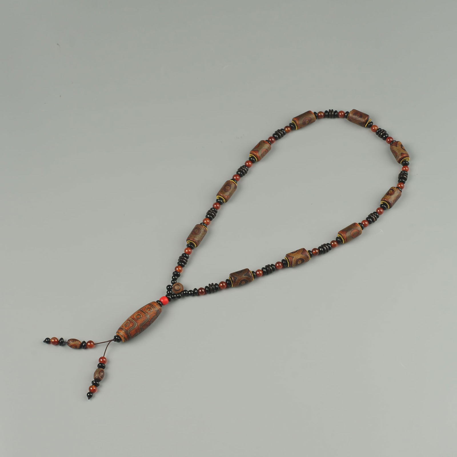 Tibetan agate dzi necklace: Title:Tibetan agate dzi necklace Origin:Asian private collection Date/Period:20th Materials: Description:Size: about 31x21x12cm, Early 20th Century Bronze buddha statue, Tibetan Antique Bronze buddha