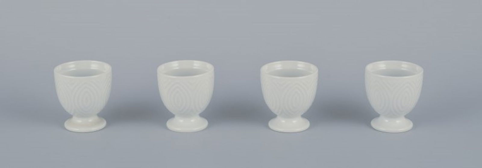 Axel Salto for Royal Copenhagen. Four egg cups in white porcelain. Circa 1960s.: Axel Salto for Royal Copenhagen. Four egg cups in white porcelain. Dating: Circa 1960s. Designed by Axel Salto in 1956. In perfect condition. First factory quality. Dimensions: Height 5.5 cm x Diamete