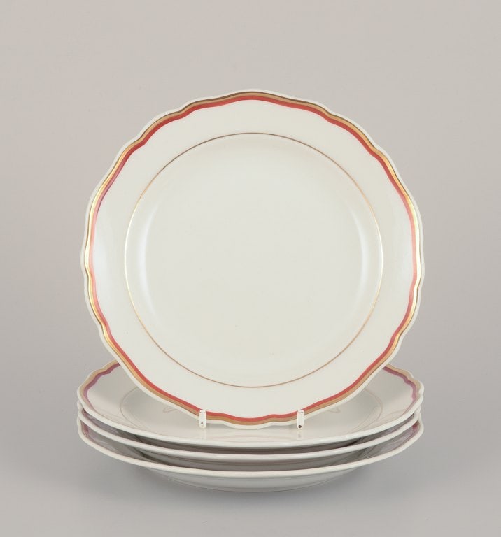 Meissen, Germany. A set of four plates. Decorated with coral red and gold-colored trim. Art Deco. (1 of 4)
