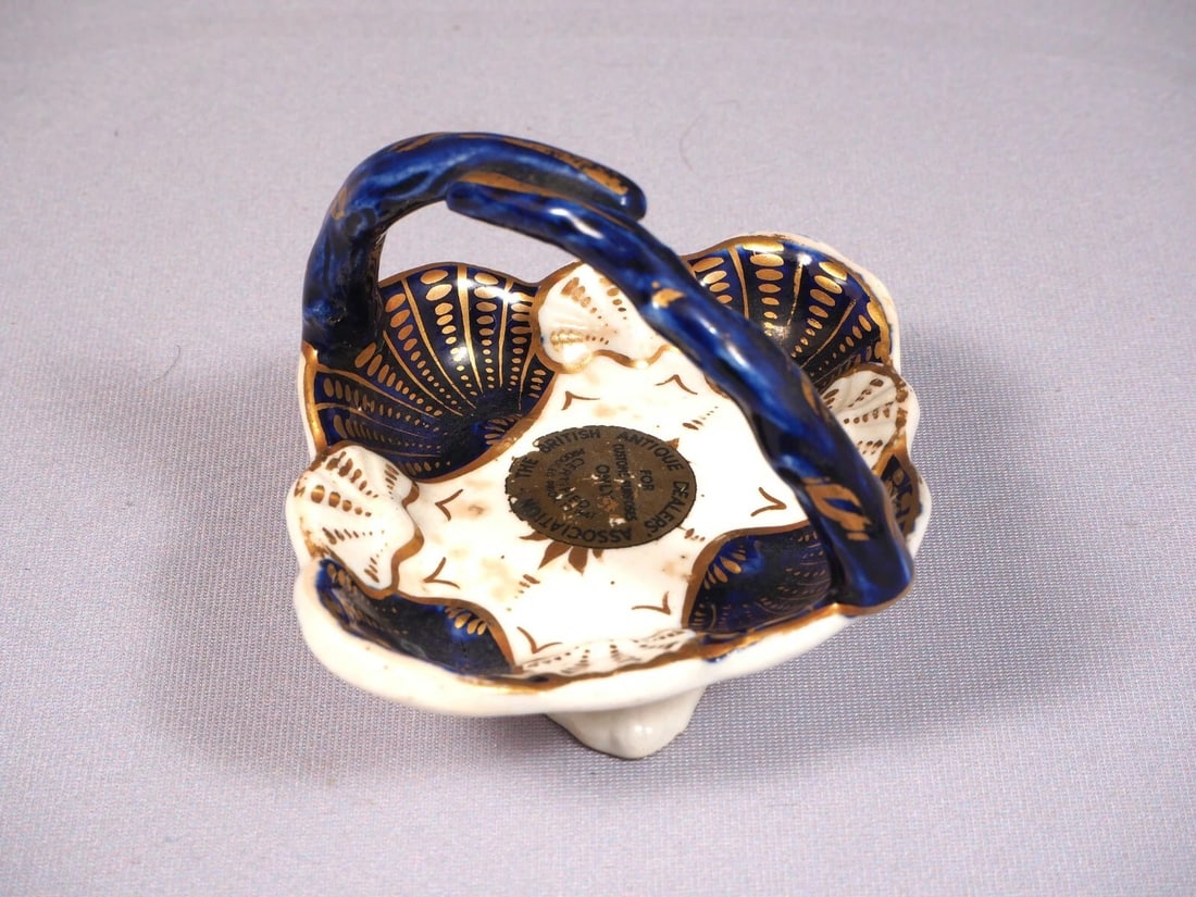 Antique Porcelain Cobalt Basket Tray Candy Nut Dish Handles Certified 1847: This is an exceptional small Basket/Nut Dish/Tray.. It is in cobalt blue and gold. It bears and British antique Dealers Association certifying that is made prior to 1827. It is aprox. 3 1/4" by 3" at