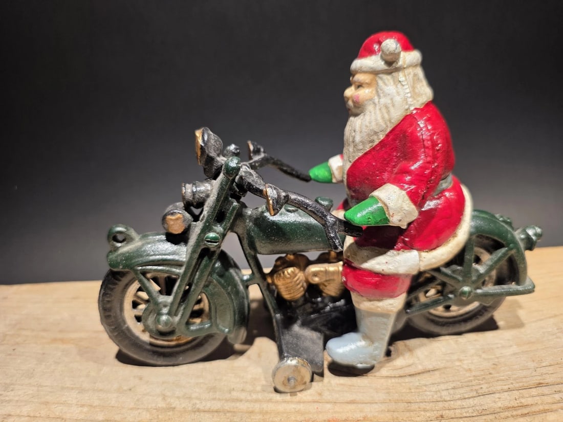 8 1/2" Cast Iron Santa on Patrol Motorcycle: 8 1/2" Long Heavy Cast Iron +- 4lbs Such a neat reproduction cast iron motorcycle! As you can see this heavy cast iron pull toy motorcycle was wonderfully hand painted and distressed to look like an o