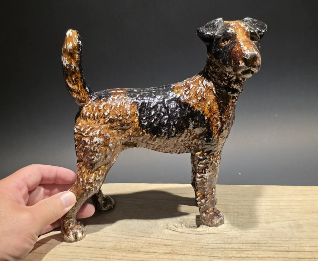 8" Cast Iron Fox Terrier Dog Door Stop: 7.5 W x 8 H Great heavy reproduction cast iron terrier dog. All cast iron hand painted, slightly distressed as shown in the images. These doorstops were often produced by companies like Hubley Manufac
