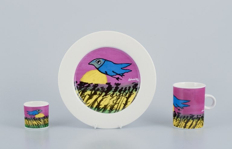 Corneille (Guillaume Cornelis van Beverloo), Dutch CoBrA artist (1922-2010). Coffee cup, plate, and: Corneille (Guillaume Cornelis van Beverloo), Dutch CoBrA artist (1922-2010). Coffee cup, plate, and egg cup in porcelain decorated with birds over a field in sunrise. From the 1980s/1990s. In perfect