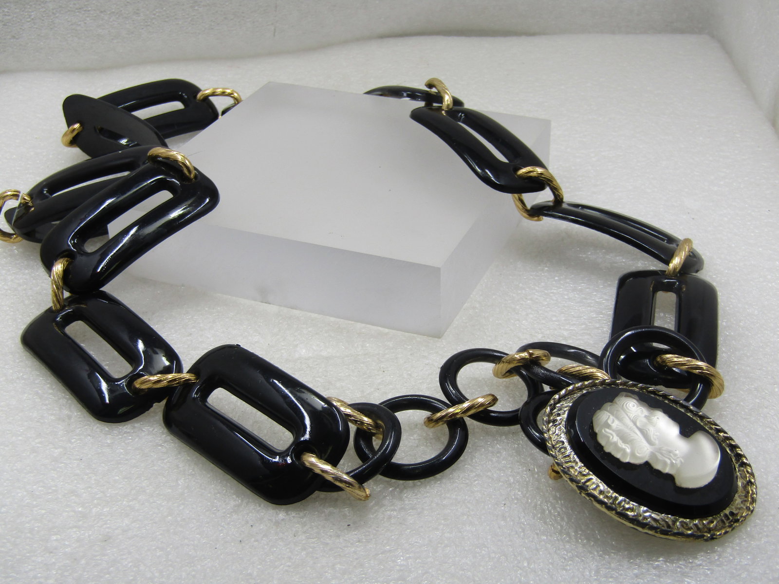 Vintage Black Lucite wtih Cameo Drop Belt, 38", 1960's: Vintage Black Lucite wtih Cameo Drop Belt, 38", 1960's. This has a hook clasp. The links are blacked, rounded corner rectangular links with open center and a chunky gold matching shape connector link.