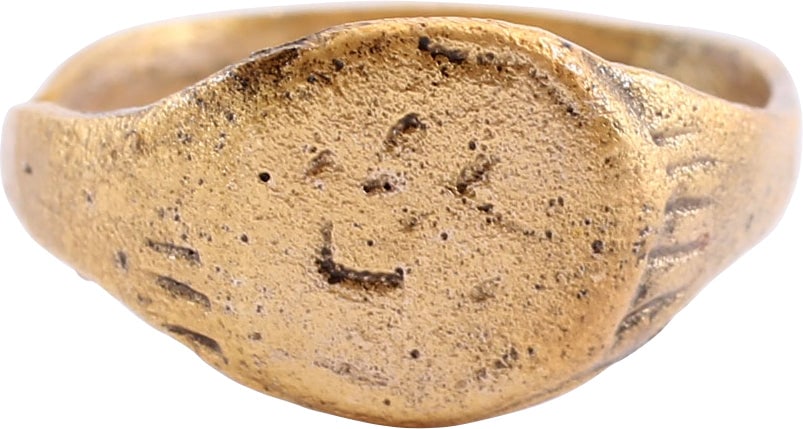 ROMAN/BYZANTINE RING C.5TH-8TH CENTURY AD, SIZE 6 ½: Gilt bronze, size 6 ½ with 2.4mm rounded face band flaring to the radially fluted shoulders. Raised circular bezel with cabalistic ciphers suggesting that it was the ring of a sorcerers, possibly