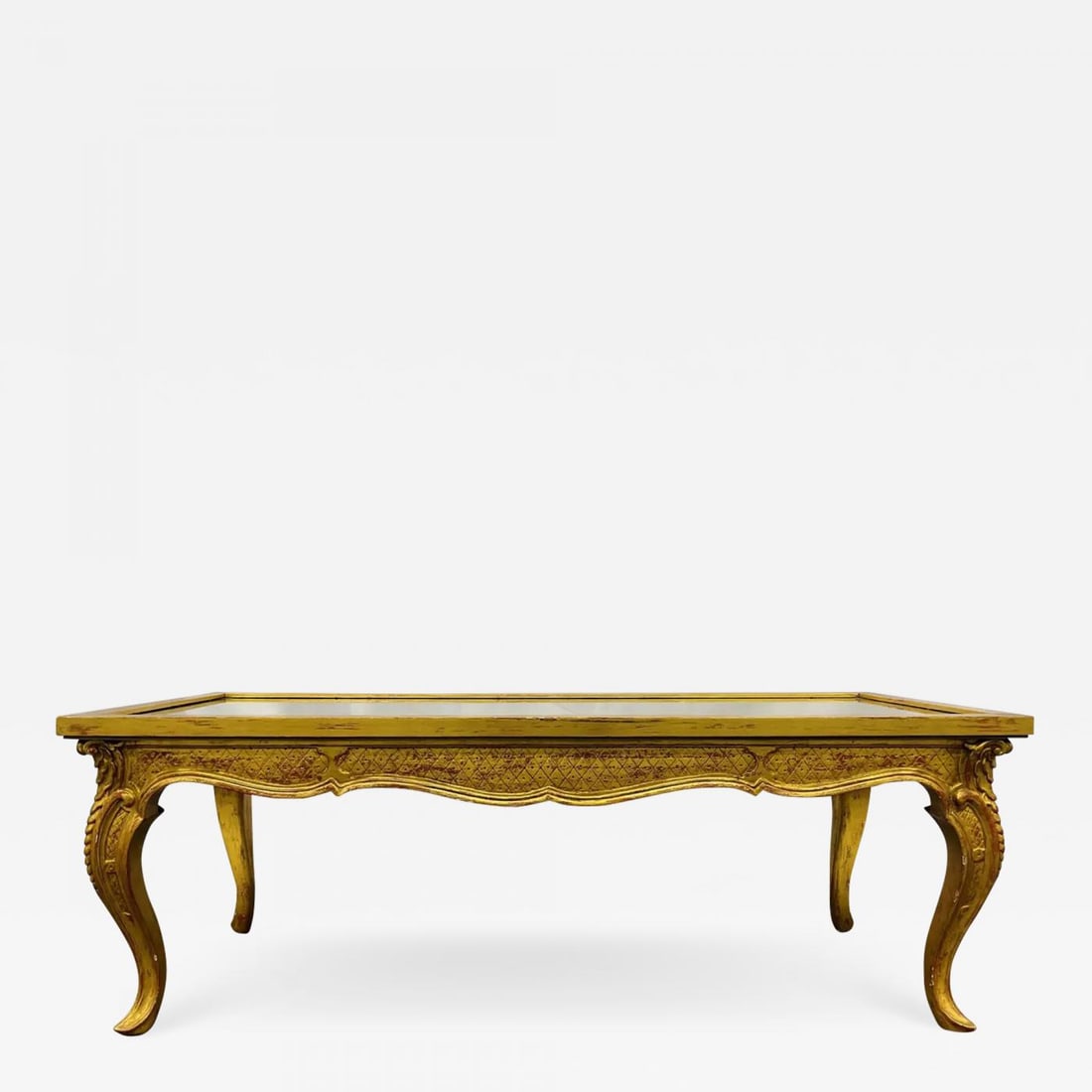 Petite Hollywood Regency Style Coffee Table, Giltwood Base, Antiqued Mirror Top: Description: Petite Hollywood Regency style coffee table, giltwood base, antiqued mirror top Small wooden coffee table by an unknown French designer having decorative carved wooden legs in a distresse