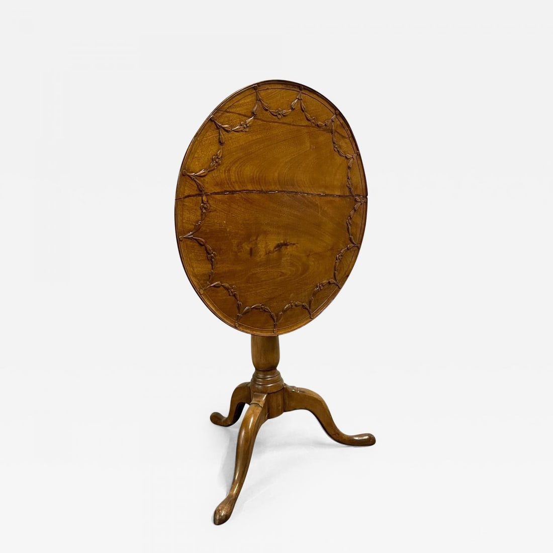 19th Century American Pie Crust Table, Tilt Top, Solid Wood Carved: Description: A fine 19th century pie crust tilt top table having solid wood carved construction in the Queen Anne Style. Age split across the top of the table. Dimensions: Dimensions H. 28 in; Diam. 2