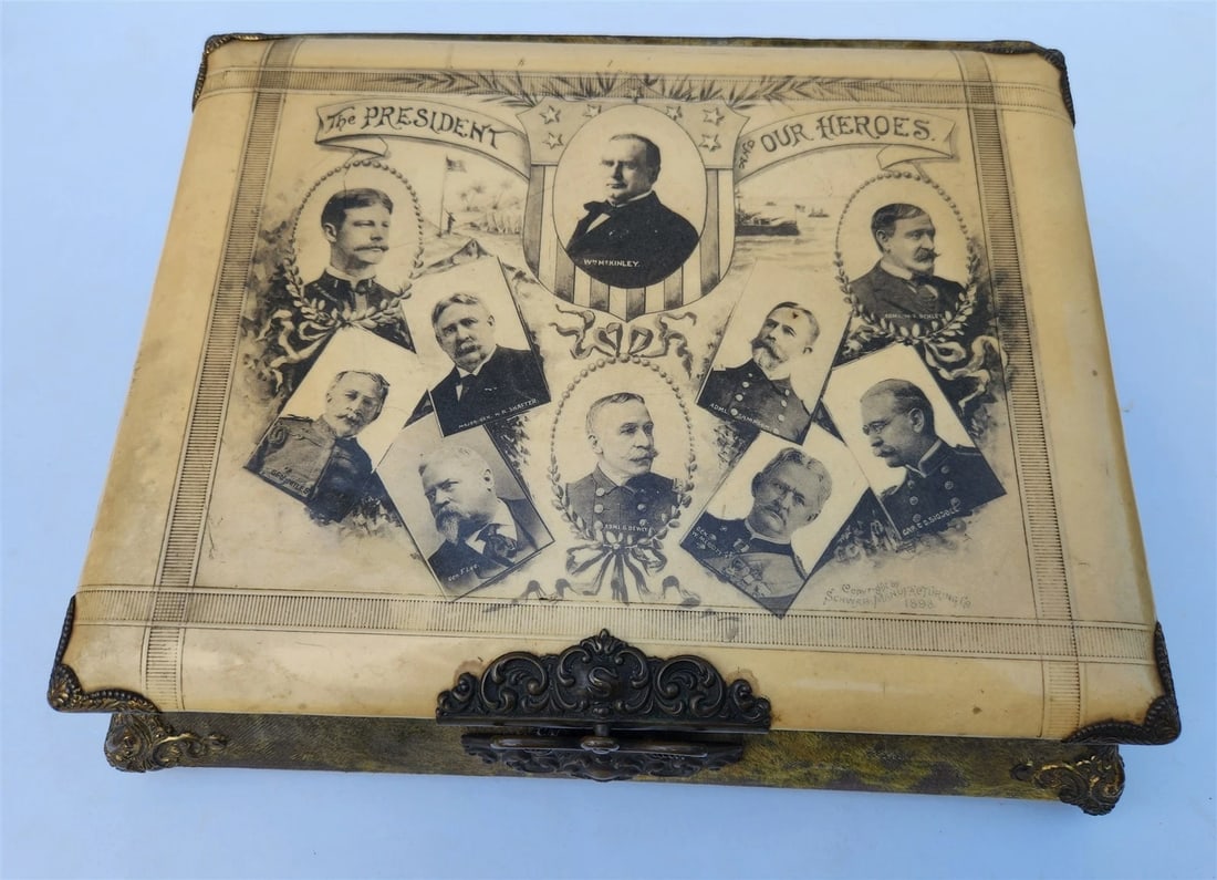 1898 PRESIDENT McKINLEY PHOTO ALBUM WIND-UP MUSIC MOVEMENT Spanish-American War: 1898 (dated) PHOTO ALBUM - WITH WIND UP MECHANICAL MUSICAL MOVEMENT in WORKING CONDITION Folio. Size of the album 9 by 11 inches Size of the base 10 by 12.5 inches Height 3.5 inches Celluloid cover wi
