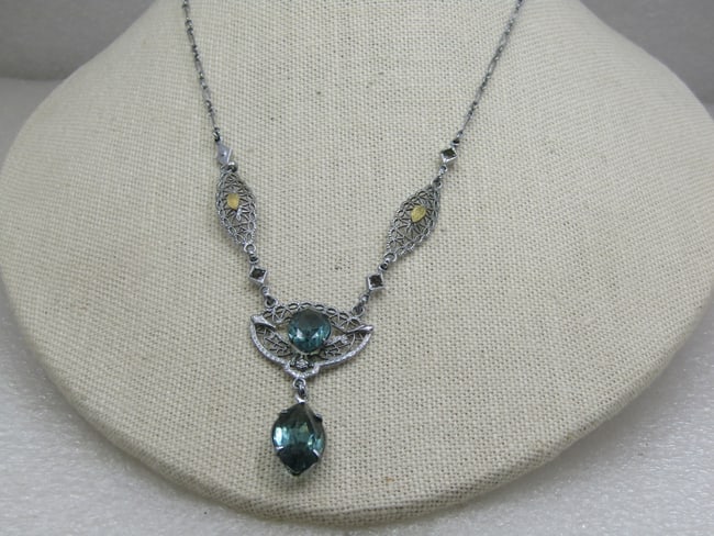 Modern Art Deco Rhinestone Filigree Lavalier Necklace, 16": Modern Art Deco Rhinestone Filigree Lavalier Necklace, 16". 1.75" filigree drop with two large aqua rhinestones - marquise - one is 12mm by 8mm and the other 18mm by 10mm. The filigree links across th