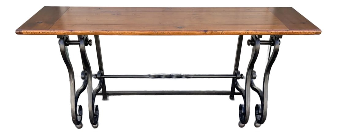 Baker Furniture Wrought Iron and Rustic Pine Sofa Console Table: Baker Furniture wrought iron and distressed rustic pine sofa table. This sofa table has an intentionally distressed walnut finish on pine over top a sturdy base of sleek scrolling and intricately shap
