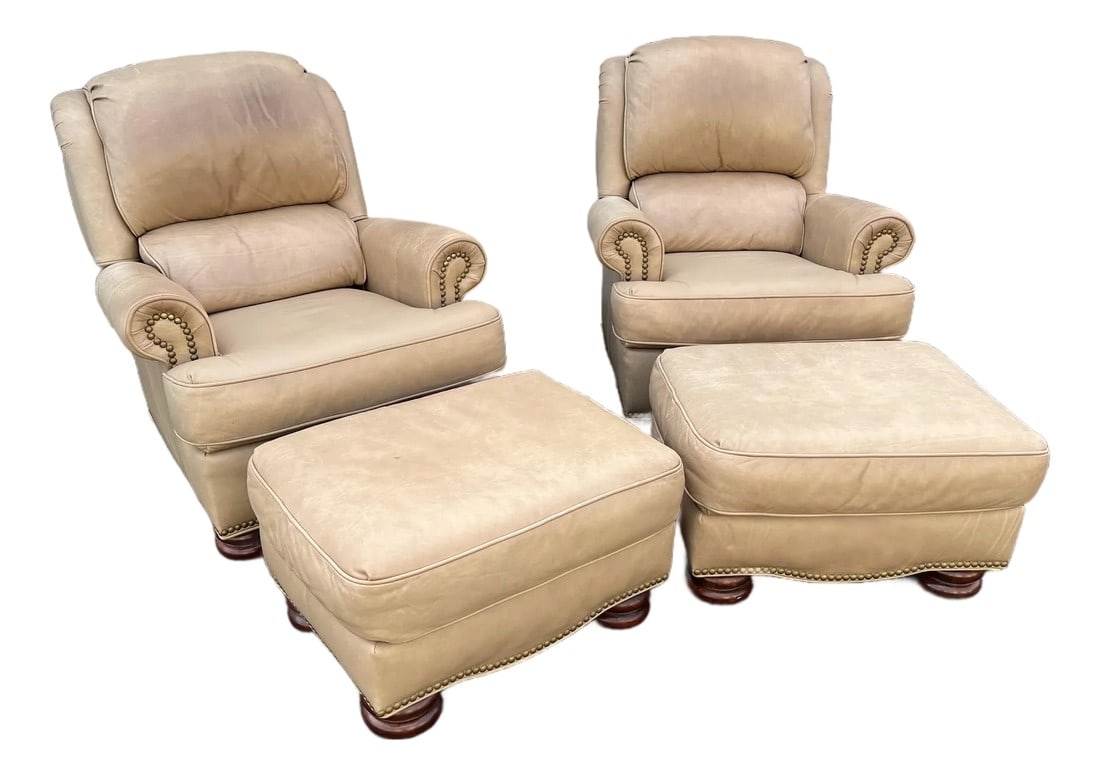 A Pair of Bradington Young Leather Recliners and Ottomans- 1990's: A pair of Bradington Young tilt-back reclining chairs and ottomans. This set of lounge chairs and ottoman stools are upholstered in top quality tan leather with nailhead accenting. Each chair has a pu