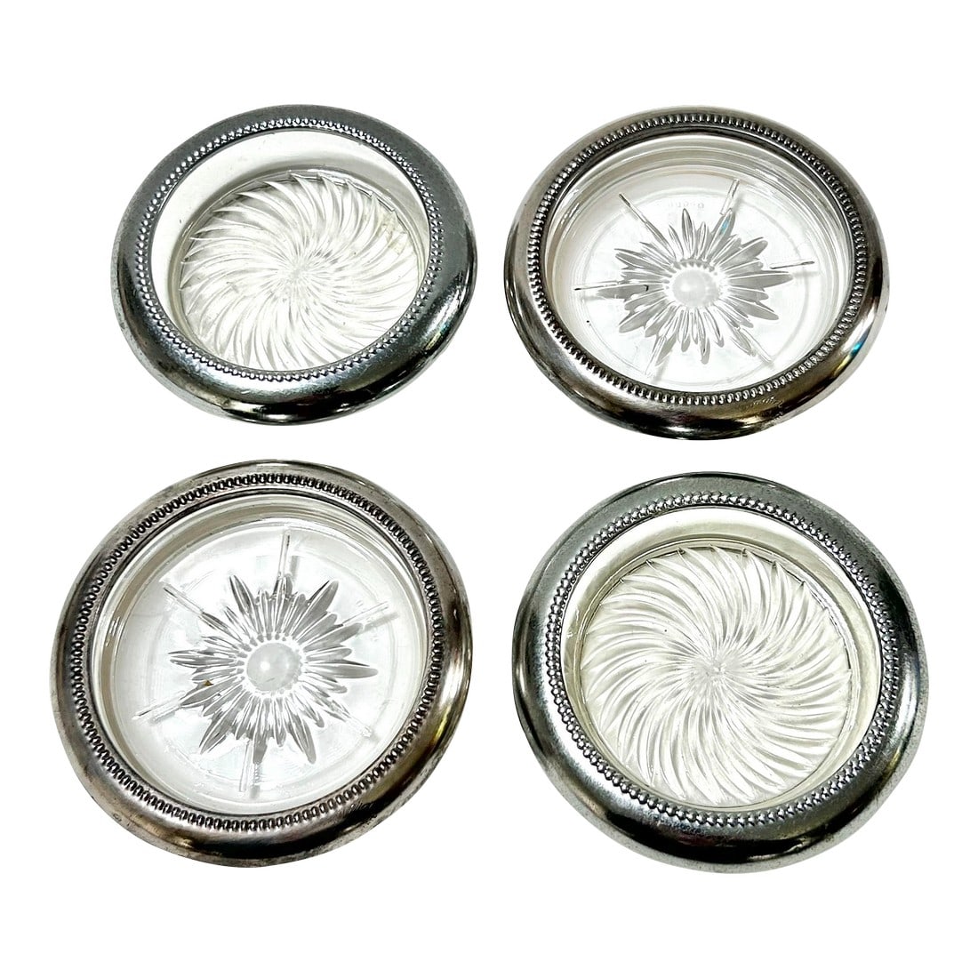 Vintage Silverplate & Glass Coasters - 4 Pieces: 2 wonderful sets of silver and glass/crystal coasters. Both set have a lovely star motif. One set is made by Park Sherman and the other by Leonard of Italy. Width: 3.75" - 4" Height: .75" Condition: A