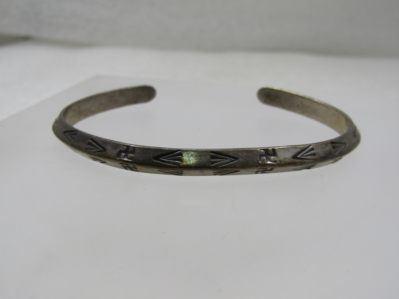 Vintage Sterling Southwestern Stamped Cuff Bracelet, 6.25", 1960's-1970's: Vintage Sterling Southwestern Stamped Cuff Bracelet, 6.25". This is ridged down the center of the appx. 4.5mm bracelet which gives the bracelet an angeled look with a mix of southwestern/Native Americ