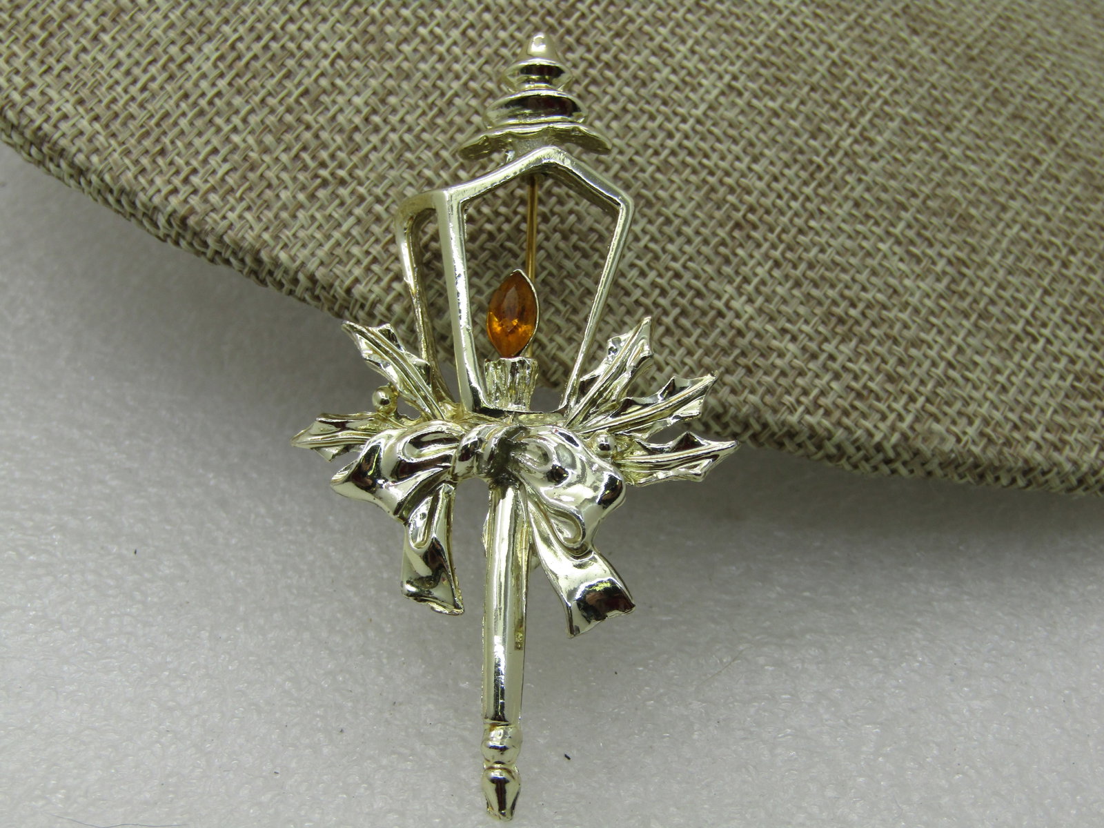 Vintage Christmas Lampost Topper Brooch, Gold Rhinestone Flame, 1960's-1970': Vintage Christmas Lampost Topper Brooch, Gold Rhinestone Flame, 1960's-1970', Gold tone with Silver tone bow. 3" tall and 1.5 wide. Very good condition. Not signed by the maker. (INV. W. 92620.4 SS285