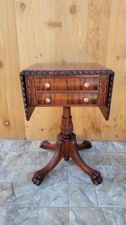 Antique Empire Carved Flame Mahogany Drop Leaf Sewing Work/Side Table: Vintage from before 2000 Antique Empire Carved Flame Mahogany 2 Drawer Drop-Leaf Sewing Work/Side Table This gorgeous 19th century balanced and proportioned drop-leaf sewing work/side table is crafted