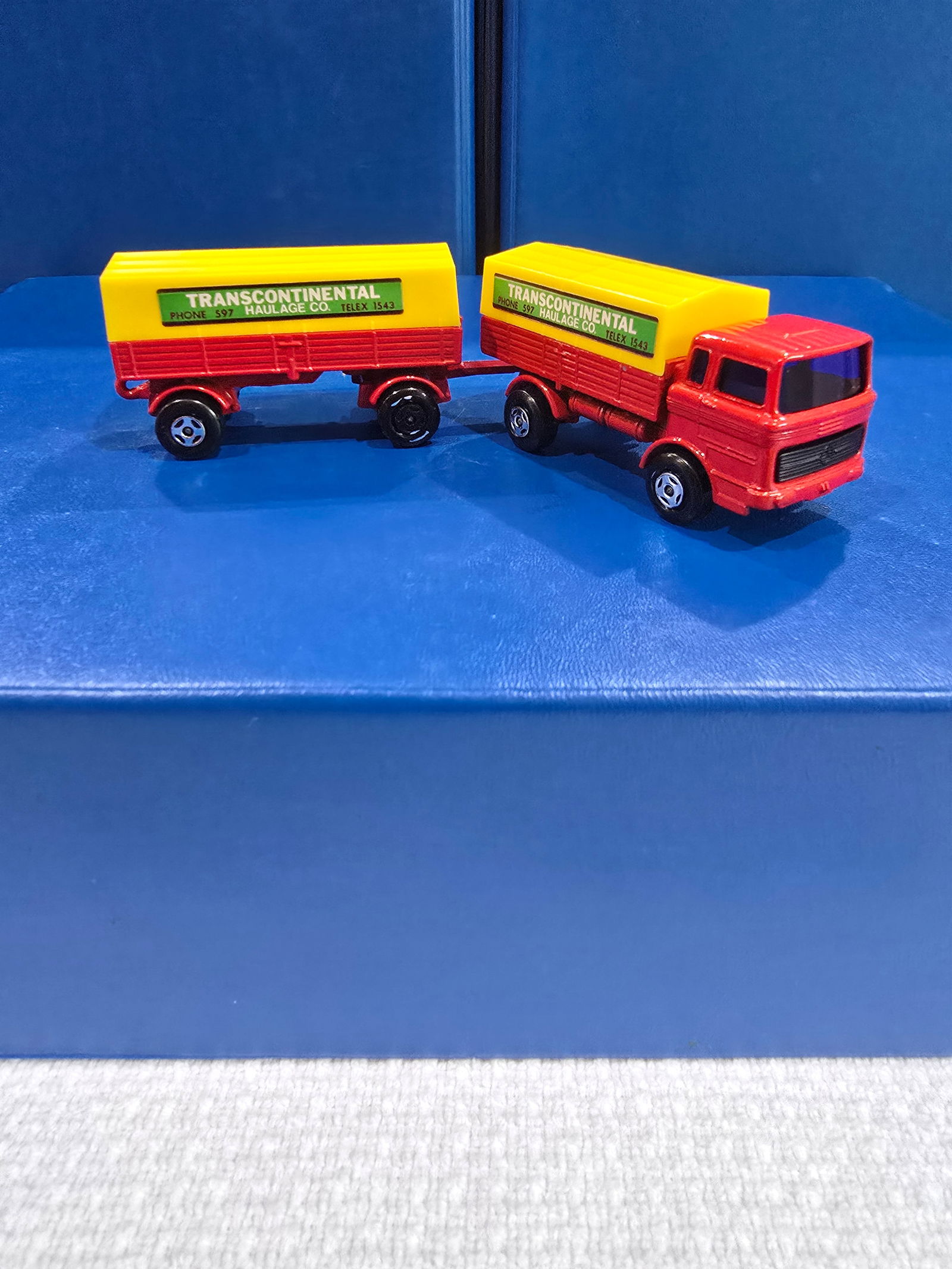 Twin Pack, red cab and trailer, yellow top covers, black axel clips, 4 spoke wheels, purple windows: Title: Matchbox Suprefast Mercedes Truck and TrailerDescription: Twin Pack, red cab and trailer, yellow top covers, black axel clips, 4 spoke wheels, purple windowsDate/Period: 1978Materials: metal Di
