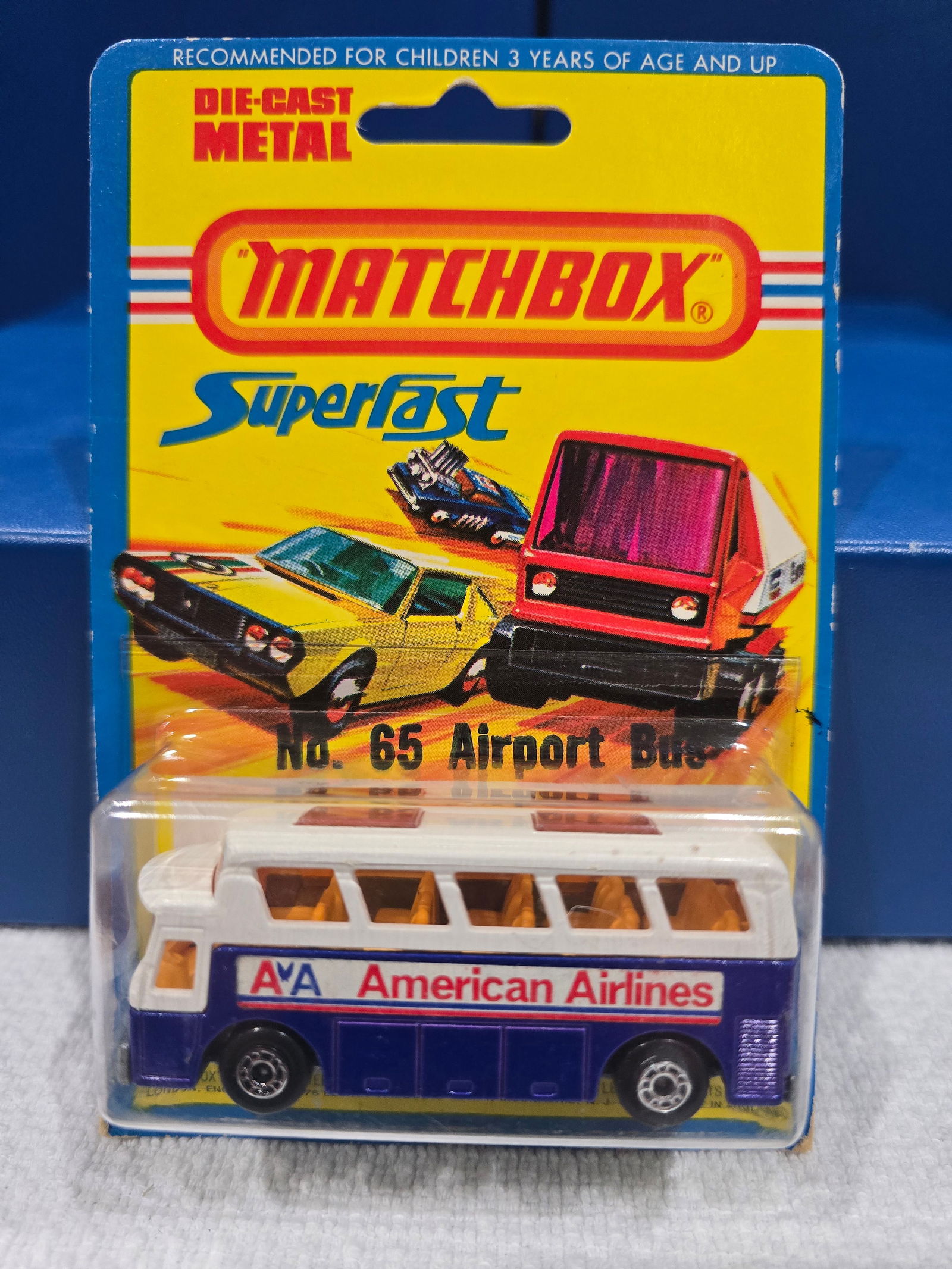 #65 Airport Bus, American Airlines, Silver unpainted base, dark amber glass, England base: Title: Matchbox Superfast BlisterDescription: #65 Airport Bus, American Airlines, Silver unpainted base, dark amber glass, England baseDate/Period: 1976Materials: MetalDimensions: 1/64 Reserve: $8.00