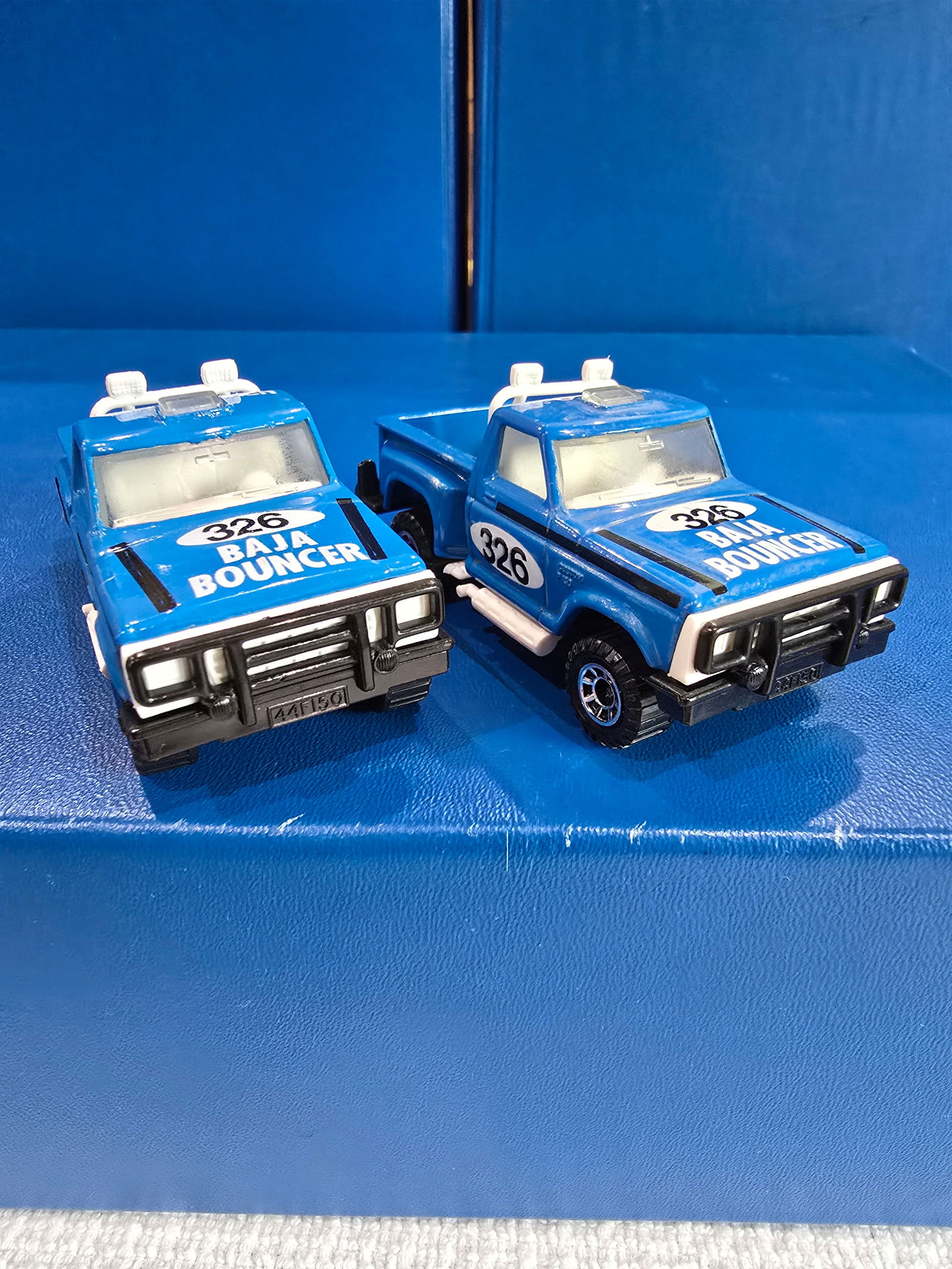 2 blue color varations, England base, clear glass, black base: Title: Matchbox BAJA BOUNCERDescription: 2 blue color varations, England base, clear glass, black baseDate/Period: 1982Materials: MetalDimensions: 1/64 Reserve: $20.00 Shipping: Domestic: Fla