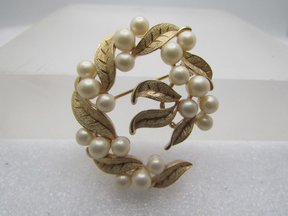 Vintage Faux Pearl Leaf Brooch, Crown Trifari, 1960's-1970's: Vintage Faux Pearl Leaf Brooch, Crown Trifari, 1960's-1970's. Gold tone in a semi-spiral shape with three faux pearls between each gold tone textured leaf that is not a circle but more of a spril desi