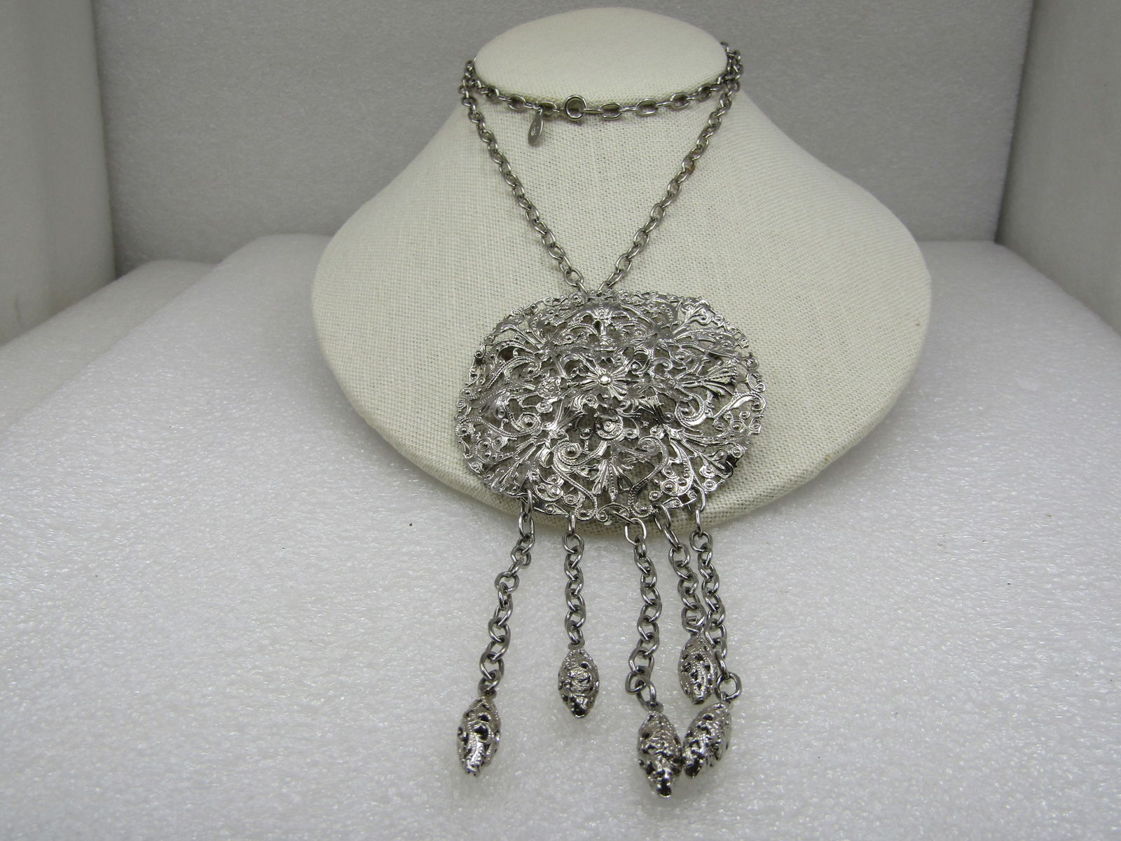 Vintage Silver Tone Filigree Drop Necklace/Brooch, 24" Signed Lisa: Vintage Silver Tone Filigree Drop Necklace/Brooch, 24" Signed Lisa. The pendant is a 2-7/8" filigree silver tone lace-like design with five filgiree drops that hand on chains three are 3.25" long and