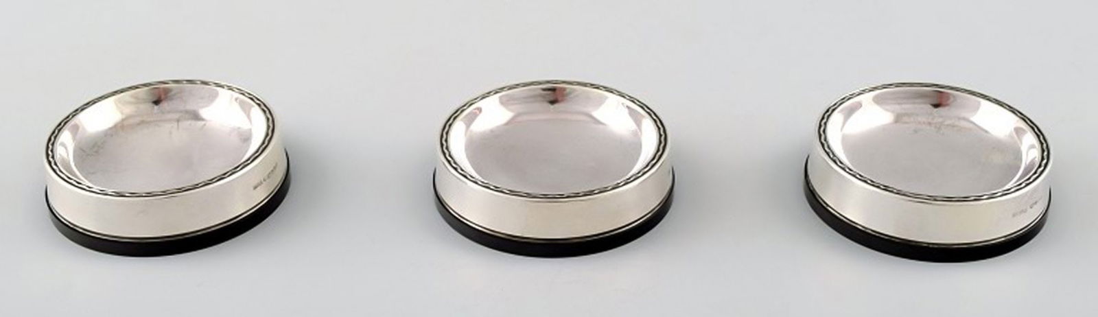 Vera Ferngren for GAB, Sweden. Three coasters in silver and bakelite.: Title:Vera Ferngren for GAB, Sweden. Three coasters in silver and bakelite. Description:Vera Ferngren for GAB, Sweden. Three coasters in silver and bakelite. Sweden, N9 = 1963. Measures 6 cm. X 1.5 cm