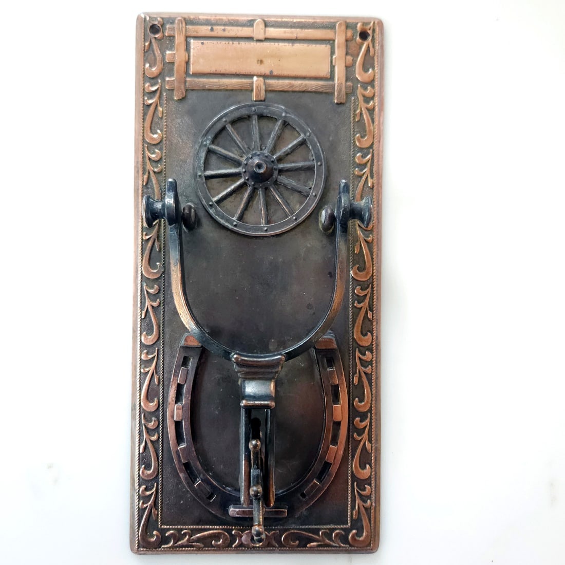 Unique Copper Spur, Horseshoe & Wagon Wheel Door Knocker: Title: Unique Copper Spur, Horseshoe & Wagon Wheel Door Knocker Description: Well-constructed and unique door knocker. Measures 9” Tall. The rowel spins, as does the wagon wheel. Copper nameplat