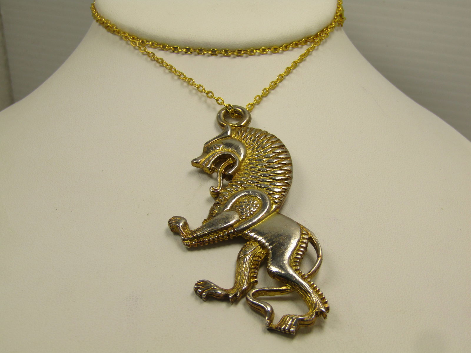 Vintage Mythical Rampant Lion Necklace, 20", 1960's-1970's: Vintage Mythical Rampant Lion Necklace, 20", 1960's-1970's. The pendant is appx. 3" tall and 1-1/3" wide. It is gold tone with some surface wear as can be seen in the photos. It has a bright gold tone