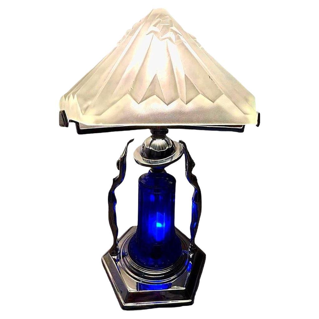 Frankart Era Art Deco Style Chrome & Cobalt Figural Lamp w/ Vivian Glass Shade: Beautiful Art Deco-style chrome lady lamp with heavy frosted glass shade. there are two nude female sculptures along the base and a blue cobalt glass light-up shade mounted to a chrome stepped base. T