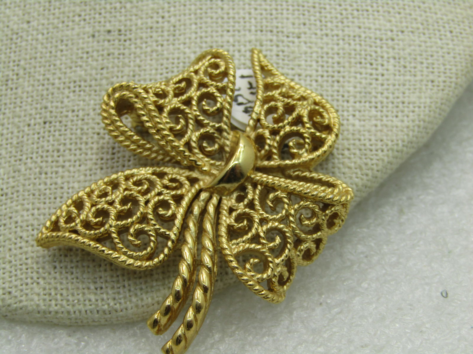 Vintage Crown Trifari Filigree Bow Brooch, 1960's, 2": Vintage Crown Trifari Filigree Bow Brooch, 1960's, 2". Gold tone - open scrolled with twist like double tail stems - is this a bow, a clover, or a blossom - it is likely a bow but it has a modern desi
