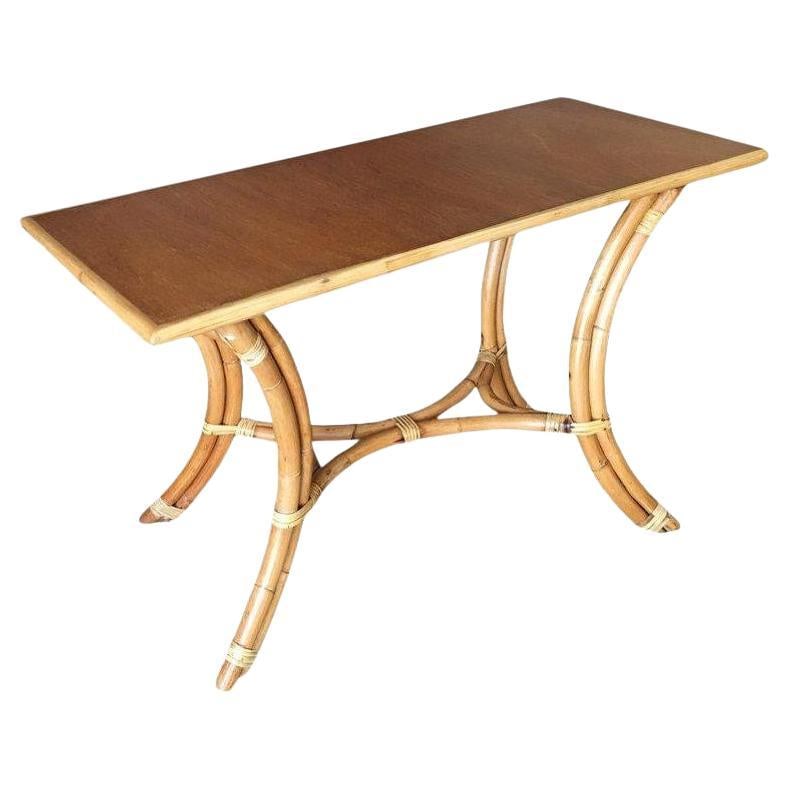 Restored Rattan "Hour Glass" Sofa/Console Table with Mahogany Top: Swoop leg sofa or console table with a mahogany tabletop featuring a unique hourglass appearance. 1950, United States We only purchase and sell the best and finest rattan furniture made by the best an