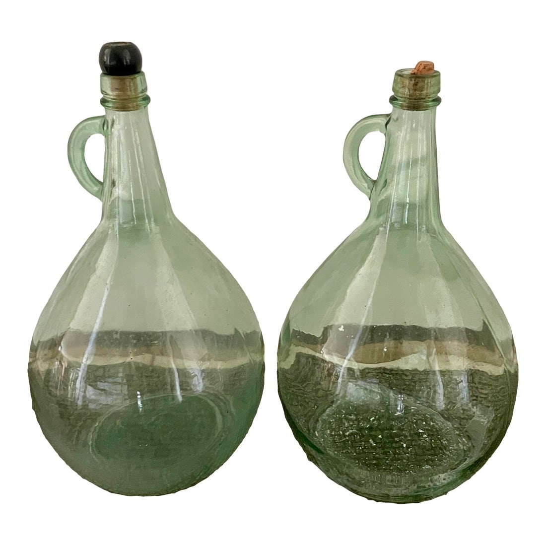 Pair of Vintage One-Gallon Green Glass Jugs: This Pair of Vintage One-Gallon Green Glass Jugs lends a old-world feel to any space. Condition: Alterations: Original Condition Unaltered Imperfections: Some Imperfections Condition Notes: Great vint