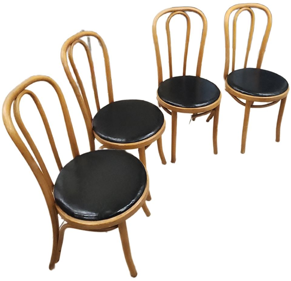 Set of 4 iconic vintage Bentwood chairs by Thonet w/ Black leather upholstered seats.: The chairs are a type of Bentwood chair that has been a classic for over a century. The most iconic designs of this style are associated with Michael Thonet, a German-Austrian cabinet maker who pionee