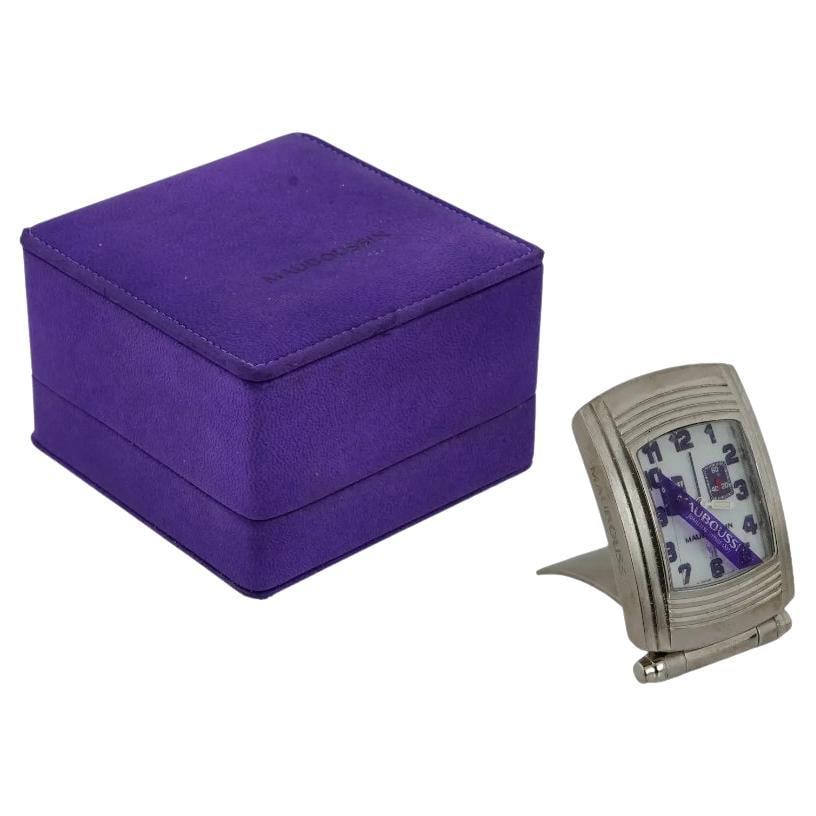 Mauboussin Fouga Stainless Steel Travel Clock IOB: A vintage alarm travel clock by Mauboussin, a French luxury brand. Fouga series. Stainless steel case with single crown. The cover flips around to serve as a base for displaying the clock. Rectangular