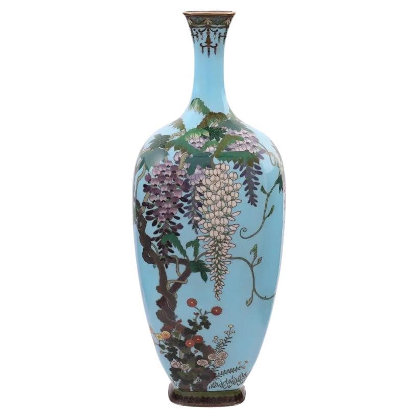 Meiji Japanese Cloisonne Enamel Turquoise Silver Wire Japanese Vase with Flowers: A high quality Japanese, Meiji era, cloisonne enamel and silver wire vase. The vase has an amphora shaped body and a narrow neck. The ware is enameled with a polychrome image of blossoming flowers, pl