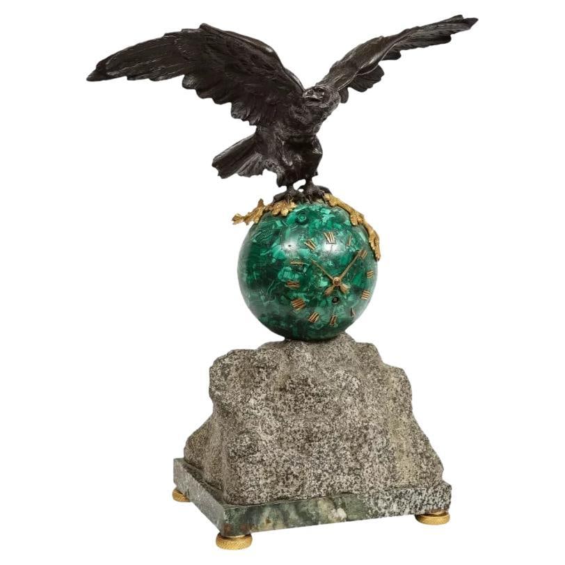 Patriotic French Patinated Bronze Eagle and Malachite Clock on Granite Base 1889: Patriotic French patinated bronze eagle and malachite clock on granite base, 1889. Very nice clock with patinated bronze flying eagle sitting on a round malachite globe-form clock. Unique piece. Clock