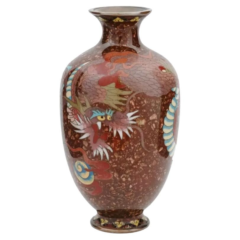 Antique Japanese Meiji Goldstone Cloisonne Enamel Vase: An antique Japanese, late Meiji Era, enamel over brass vase. Circa: early 20th century. The amphora shaped vase is enameled with a polychrome image of a dragon made in the Cloisonne technique on brown