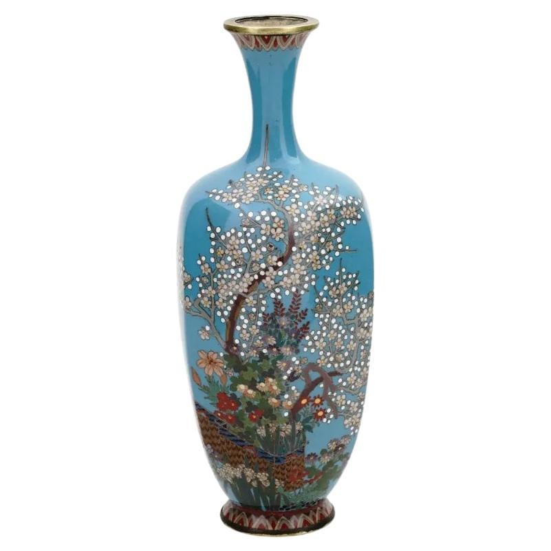High Quality Japan Meiji Cloisonne Enamel Silver Wire Vase: A high quality Japanese, Meiji era, Cloisonné enamel and silver wire vase. The vase has an amphora shaped body and a narrow neck. The ware is enameled with a polychrome image of blossoming flower