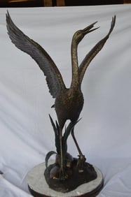 Crane standing on a stone bronze statue – Size: 28″L x 32″W x 49″H.