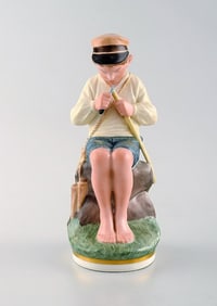 Royal Copenhagen porcelain figurine in high quality over glaze. Young boy. Model number 905. Dated