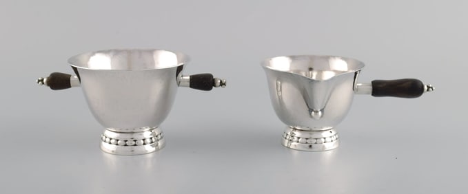 Early Georg Jensen sugar / cream set in sterling silver with handles in ebony. Dated 1915-1930.