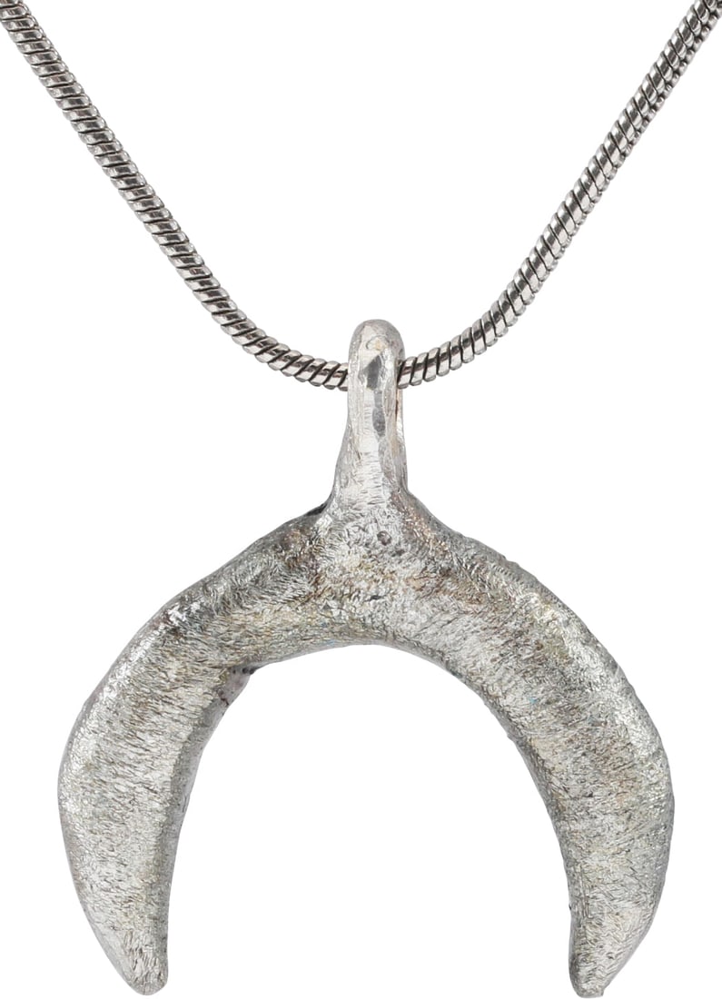VIKING LUNAR PENDANT NECKLACE, C.950-1050 AD, SIZE 6: Small example, just over 1” total height. As expert navigators, the constellations signified mystery and power to Vikings. The Moon was personified as Mani, brother to Sol the Sun, and is abunda