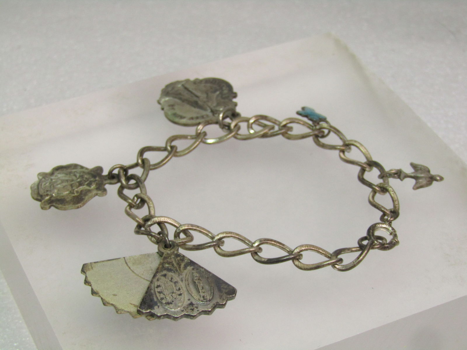 Vintage Sterling Catholic Medals Charm Bracelet, Some Guilloche, 7", Mid-Century: Vintage Sterling Catholic Medals Charm Bracelet, Some Guilloche, 7", Mid-Century. 7" long with 6mm wide curved ovallinks with textured finish on the top and bottom and smooth edges. Older style spring