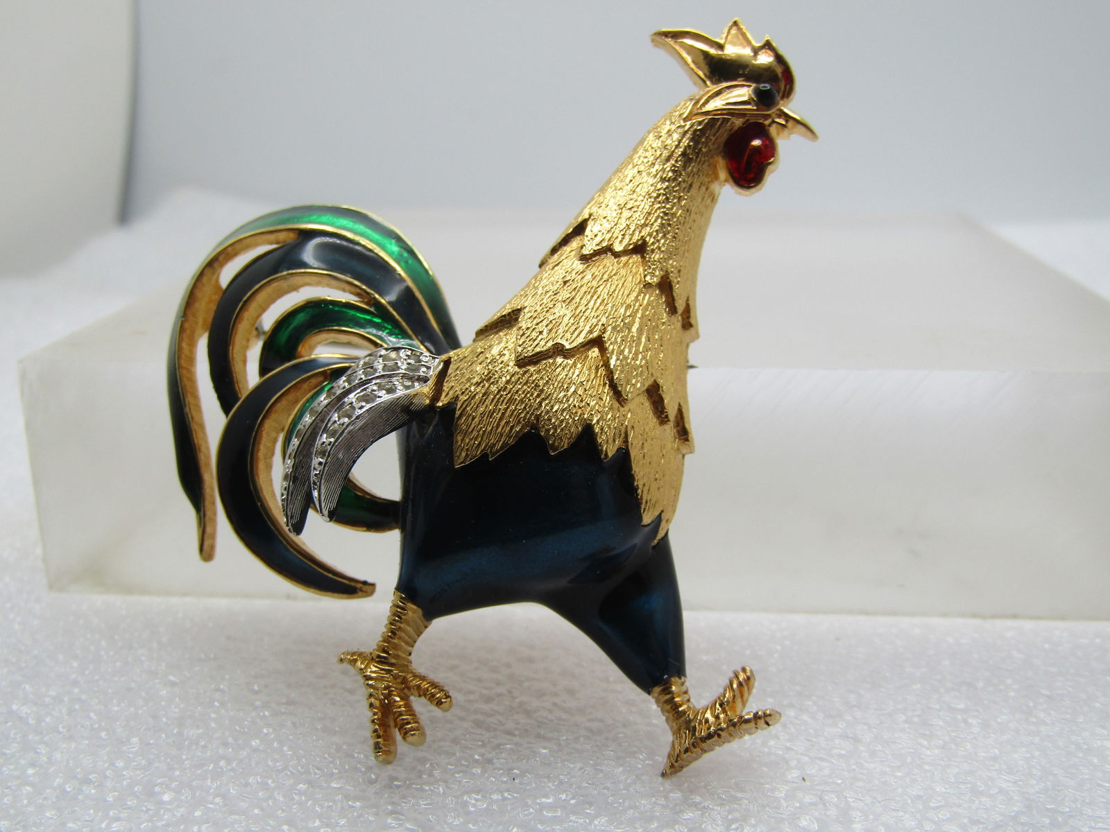 Vintage Enameled Rhinestone Rooster Brooch, Signed Jomaz, 1960's: Vintage Enameled Rhinestone Rooster Brooch, Signed Jomaz (Joseph Mazer) 1960's. Enameled in rich dark blue and green and gold tone neck and head and feed with silver tone featers against the body with