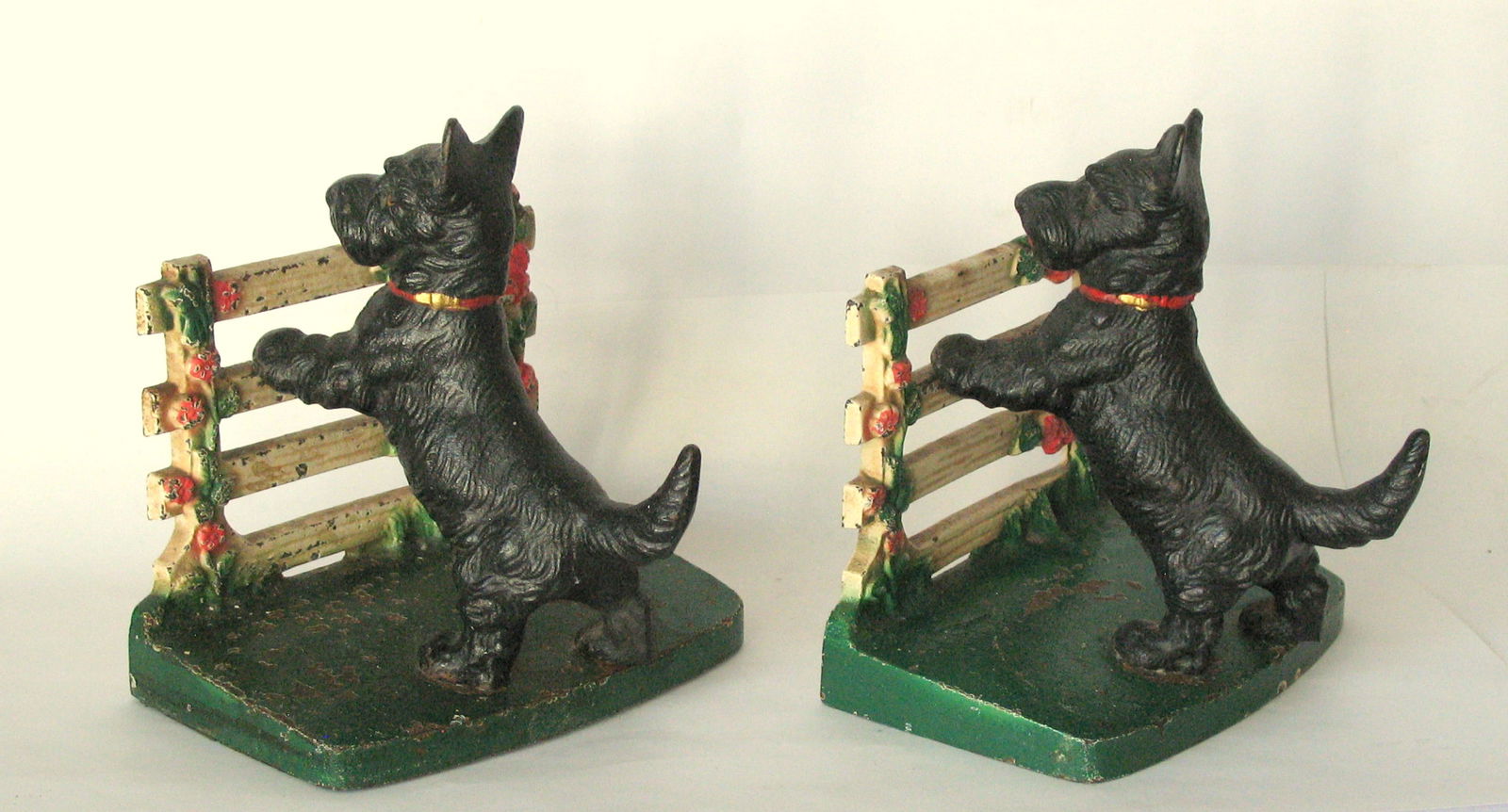 Antique cast iron Scotties by the fence bookends.: Title: Antique cast iron Scotties by the fence bookends. Date/Period: 1930's Dimension: 4 ½ X 4” x 5” high Additional Information: Nice pair of antique cast iron Scotties by the fence