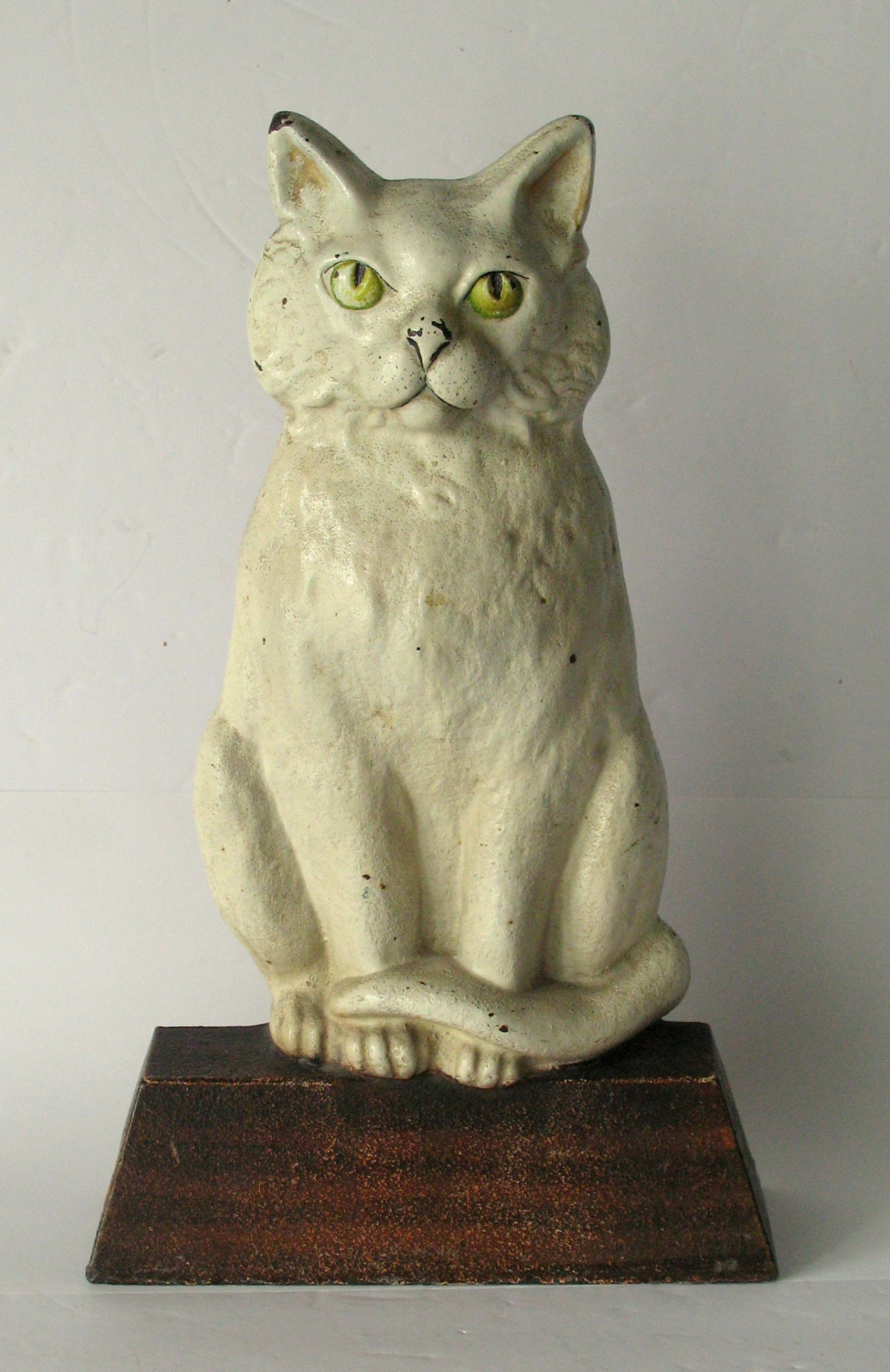 Antique cast iron large white cat door stop made by Judd.: Title: Antique cast iron large white cat door stop made by Judd. Date/Period: 1910 Dimension: 7 3/4” x 2 2/3” x 12 1/2” high Additional Information: Nice antique cast iron large cat