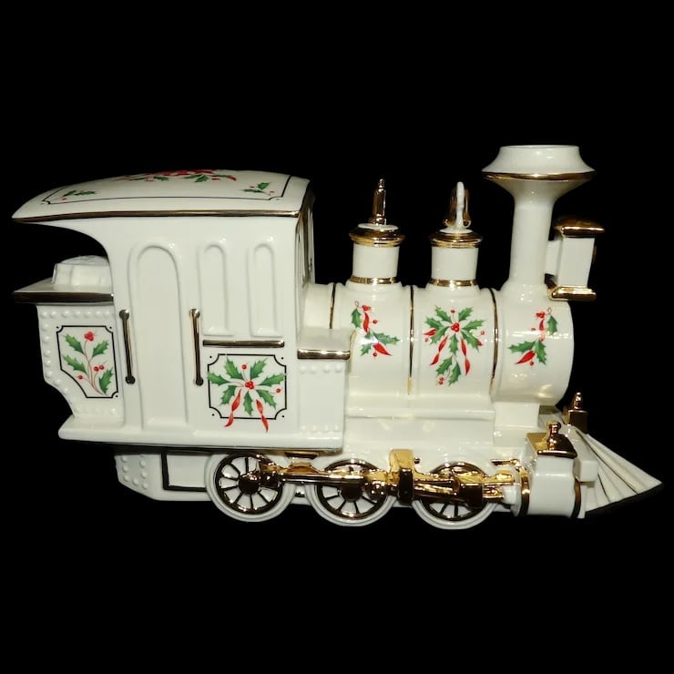Lenox Holiday Junction Train Engine Christmas Porcelain 24K Gold Accents: This Lenox Holiday Junction Train Engine Christmas Porcelain 24K Gold Accents has the smoke stack reglued (see photos). It still looks in great condition as a display piece. It measures 13” x 6